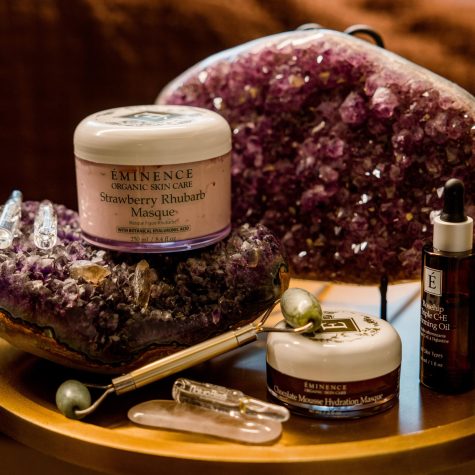 strawberry facial products on table with crystals and spa utensils